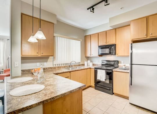full kitchen with granite counter tops and stainless steel appliances