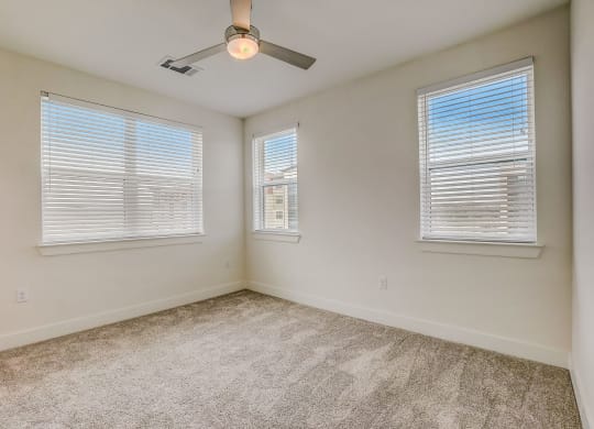 an empty room with two windows and a ceiling fan  at Aurora Watson Branch, Mansfield, Texas
