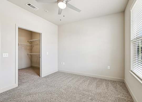A room with a ceiling fan and a doorway leading to another room. at North Creek, Texas