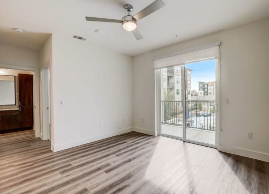 a living room with a large window and a ceiling fan at Aurora Watson Branch, Mansfield, TX
