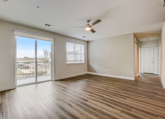 an empty living room with a balcony and a ceiling fan at Aurora Watson Branch, Texas, 76063