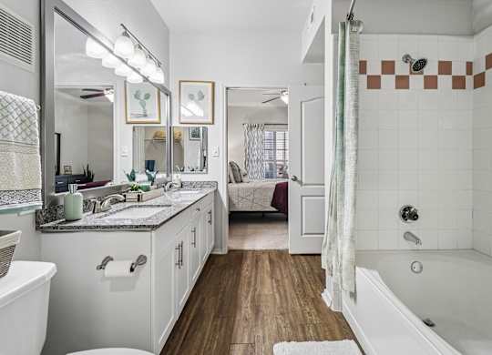 A bathroom with a white tub and a white sink.