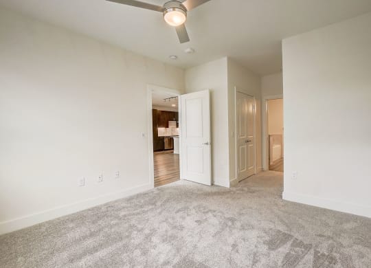 an empty living room with carpet and a ceiling fan at Aurora Watson Branch, Texas, 76063