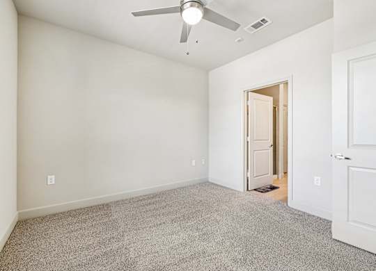 A room with a ceiling fan and carpeted floor.at North Creek, Hutto