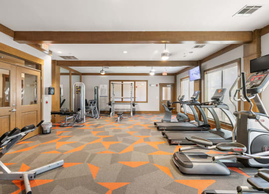 a gym with treadmills and other exercise equipment in a room at Lakeline East Apartments, Cedar Park, TX