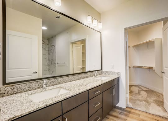 a bathroom with granite counter tops and a large mirror at Aurora Watson Branch, Texas, 76063
