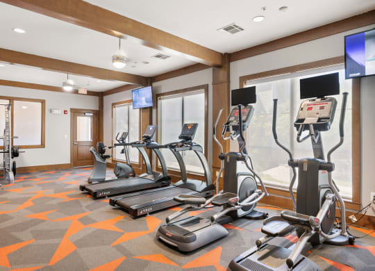 a gym with treadmills and other exercise equipment in a room at Lakeline East Apartments, Cedar Park, 78613