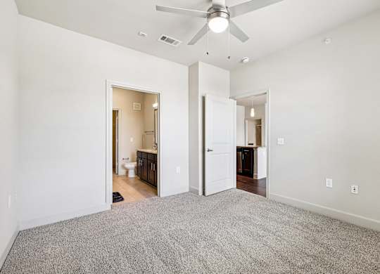 A room with a ceiling fan and carpeted floor.at North Creek, Hutto, TX