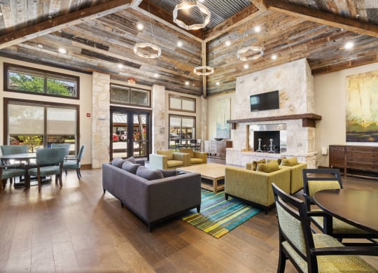 a living room with couches and chairs and a fireplace at Lakeline East Apartments, Texas, 78613
