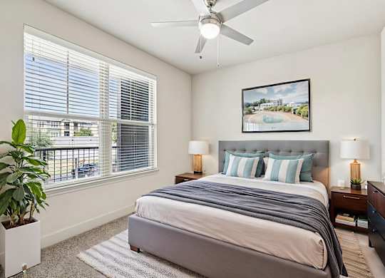 A bedroom with a large bed and a ceiling fan. at North Creek, Texas, 78634