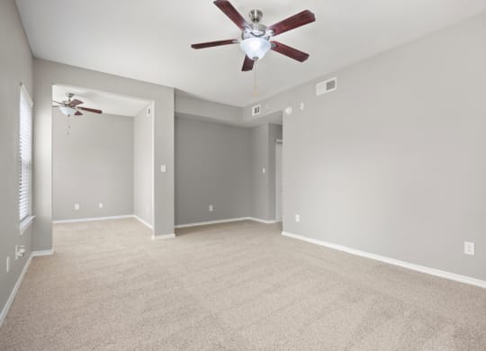 A large empty room with a ceiling fan at Waters Edge Apartment Homes, Georgetown, TX