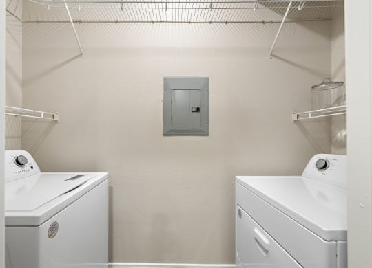 a white laundry room with two washes and a dryer at The Verandah, Texas