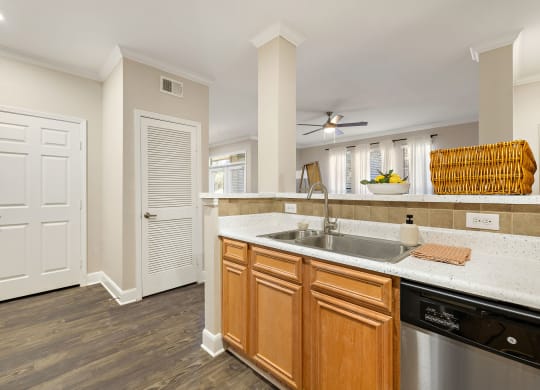 a kitchen with a sink and a door to a living room at The Verandah, Austin, 78726