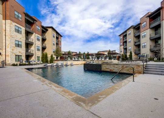 swimming pool with apartment buildings at Aurora Watson Branch, Texas, 76063