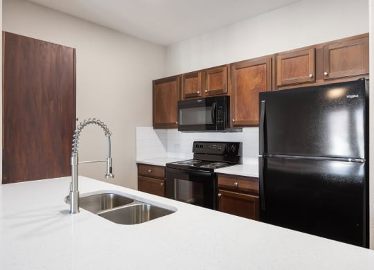 a kitchen with black appliances and white counter tops at The Fairways at Star Ranch, Hutto