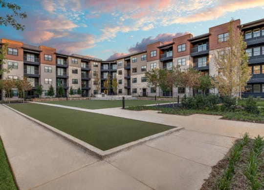a courtyard with a grassy area and apartment buildings in the background  at Aurora Watson Branch, Mansfield, TX, 76063