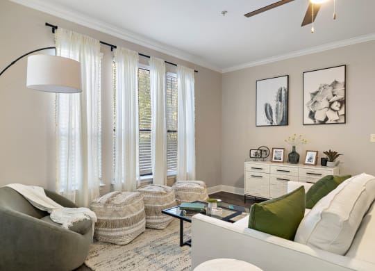 a living room with white curtains and a couch and a table at The Verandah, Texas, 78726