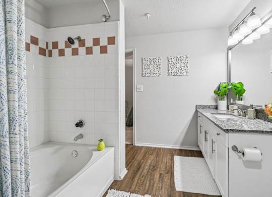 A bathroom with a white tub and a white sink.