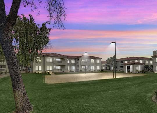 A large building with a lawn in front of it at San Montego Apartments, Arizona