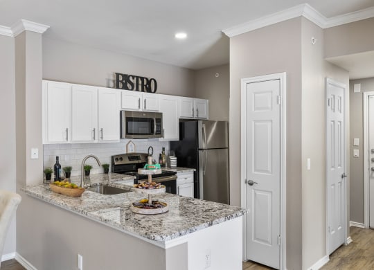 a kitchen with granite counter tops and stainless steel appliances at Sonterra Apartment Homes, Texas, 78726