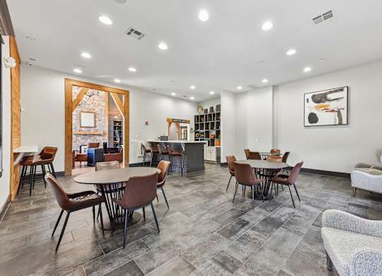 A spacious room with a dining table and chairs.