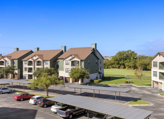 an aerial view of an apartment complex with a parking lot at The Fairways at Star Ranch, Hutto, Texas