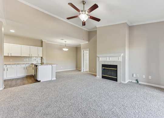 A living room with a fireplace and a ceiling fan. at Sonterra Apartment Homes, Austin, TX, 78726