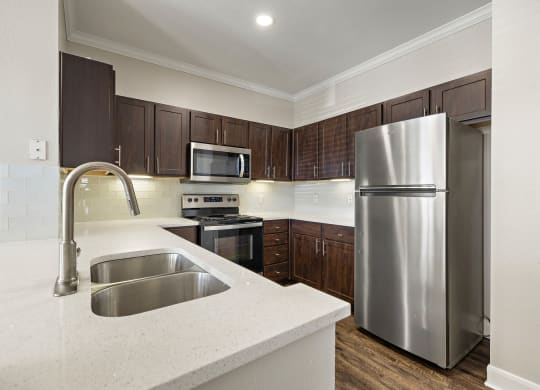 a kitchen with stainless steel appliances and white counter tops at The Verandah, Texas