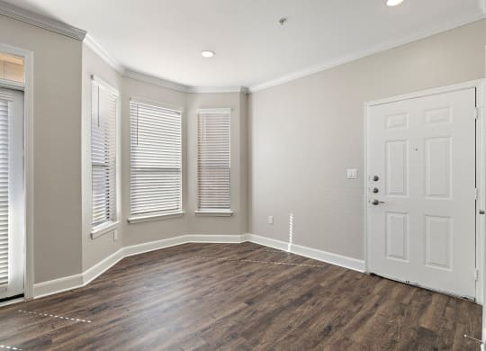 an empty living room with a white door and windows at The Verandah, Austin, TX, 78726