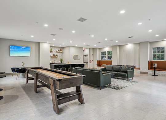 A room with a pool table and a couch.