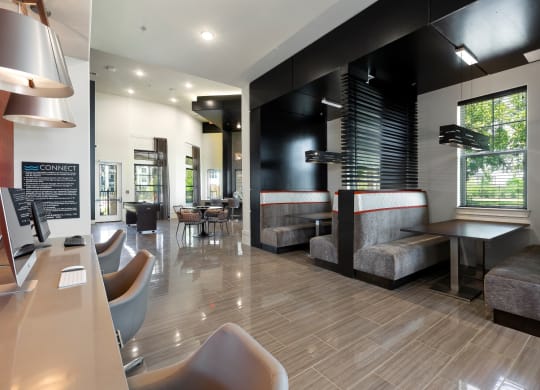 a seating area with tables and chairs at a restaurant at North Creek, Hutto