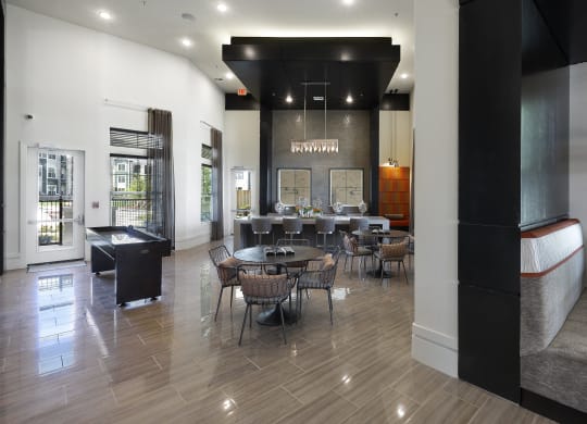 a dining room with tables and chairs and a bar in the corner at North Creek, Hutto, Texas