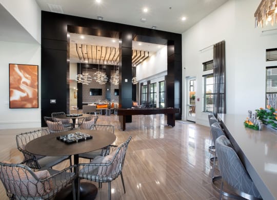a dining room with a table and chairs and a piano at North Creek, Hutto, TX