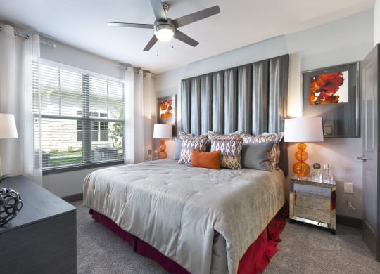 a bedroom with a large bed and a ceiling fan at North Creek, Texas