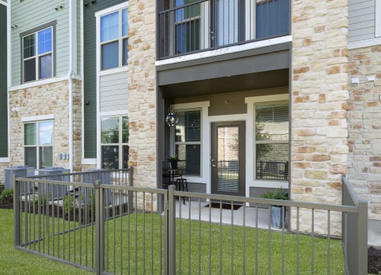 a metal fence in front of an apartment building at North Creek, Texas, 78634