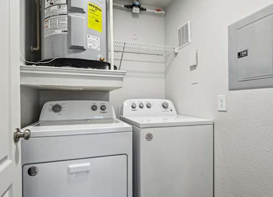 A white washing machine and dryer in a small laundry room.