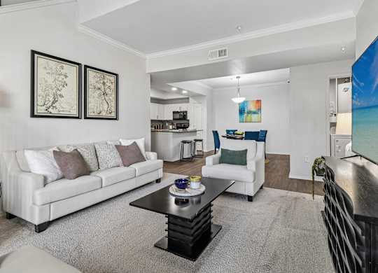 A living room with a white couch and a coffee table.