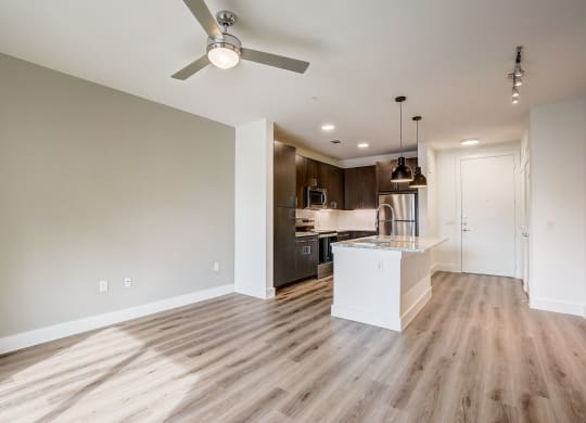 an empty living room and kitchen with a ceiling fan at Aurora Watson Branch, Mansfield, TX