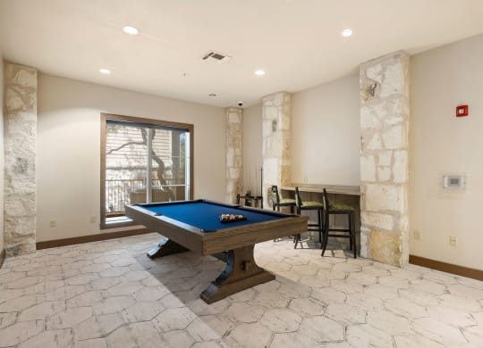 a game room with a pool table and a bar at Lakeline East Apartments, Texas