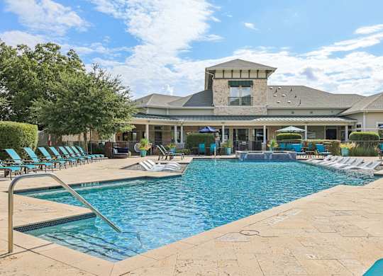 A large swimming pool with a building in the background.at North Creek, Hutto