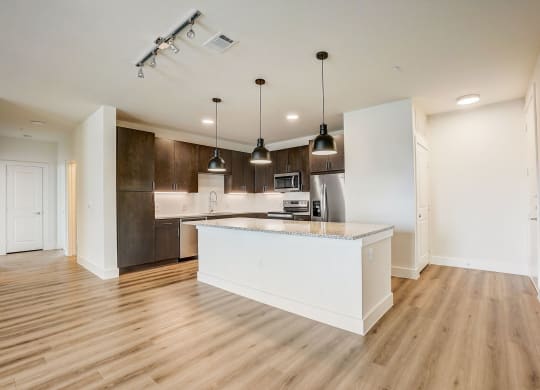 an open kitchen with a large island in the middle at Aurora Watson Branch, Mansfield, Texas