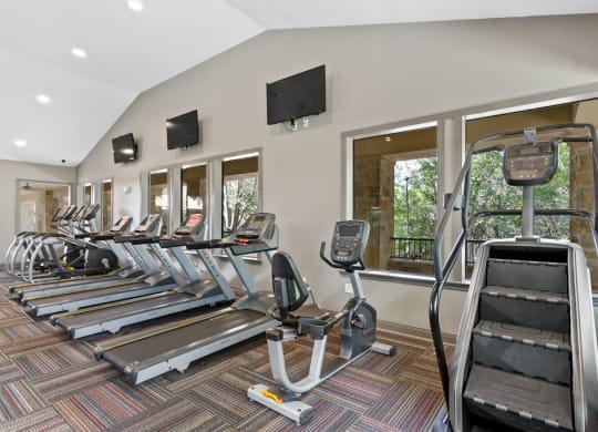 a row of cardio machines in a gym at The Verandah, Austin, 78726