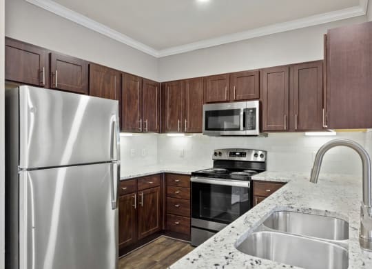 the avenues salt lake custom homes interior kitchen with granite countertops and stainless steel appliances at The Verandah, Austin