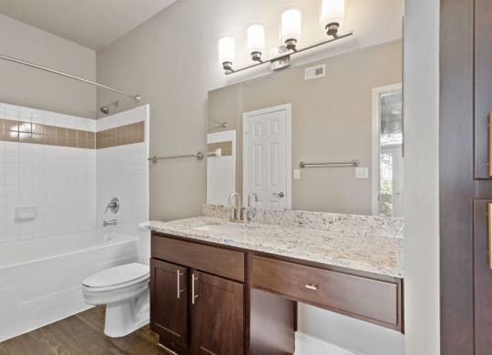a bathroom with a toilet sink and bathtub at The Verandah, Texas, 78726