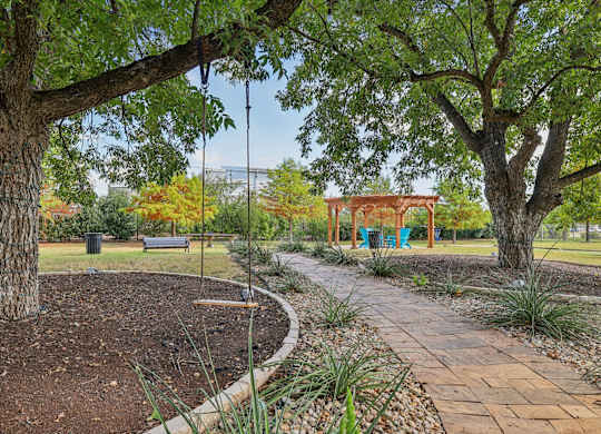 A park with a swing set and a bench.at North Creek, Texas, 78634