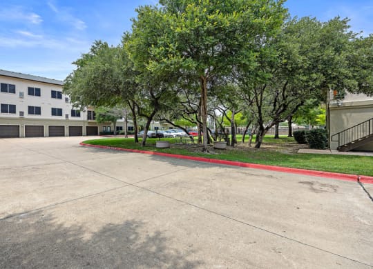 BBQ areas and mature trees at Artisan Apartments & Shops, Texas, 78729