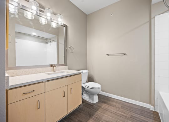 a bathroom with a toilet sink and shower at Artisan Apartments & Shops, Austin, TX