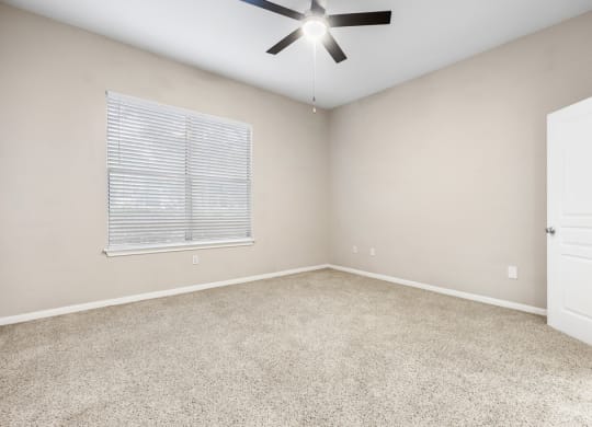 a bedroom with a ceiling fan at Artisan Apartments & Shops, Austin