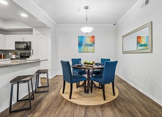 A dining room with a table set for four.