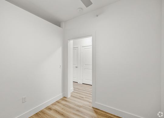 A white hallway with a door at the end. at Aurora Watson Branch, Texas, 76063